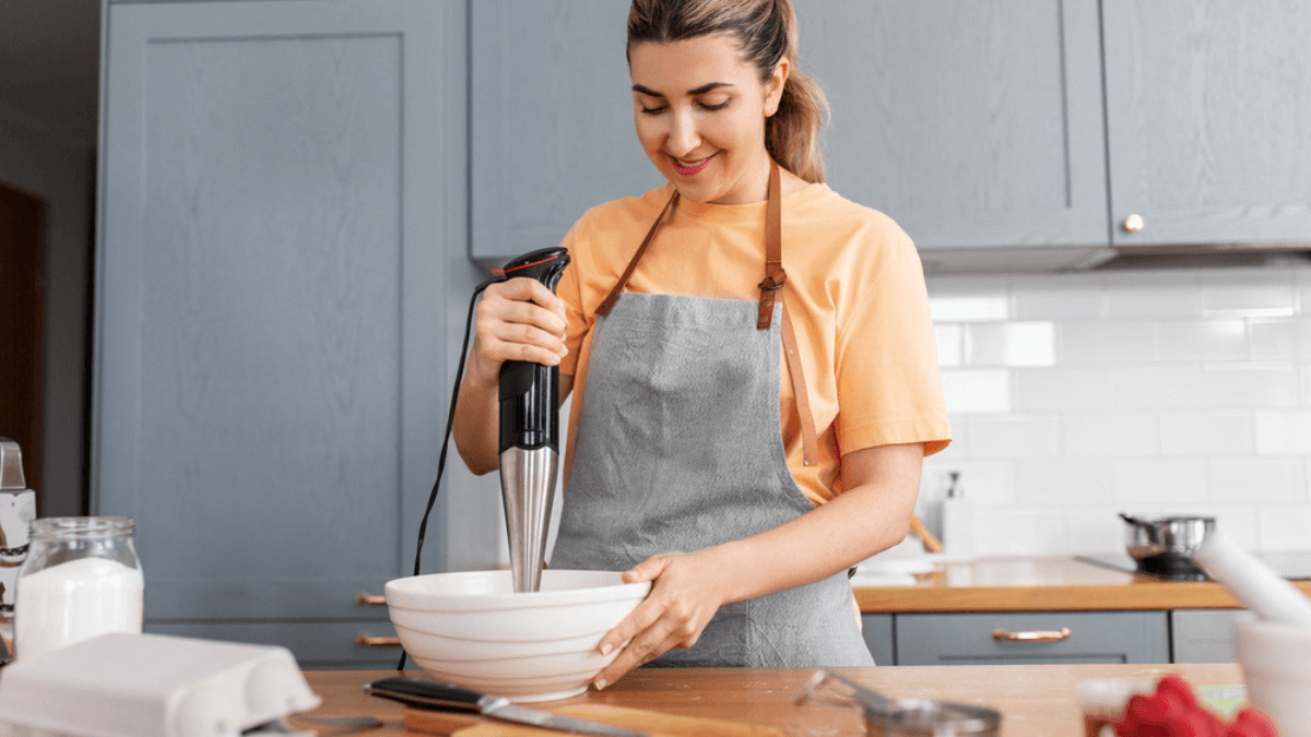 Woman using immersion blender MSN
