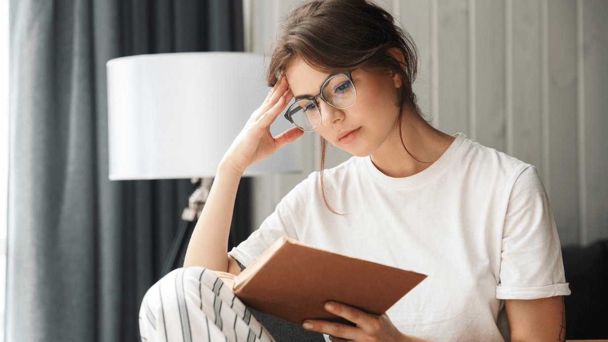 Woman with glasses reading a book MSN