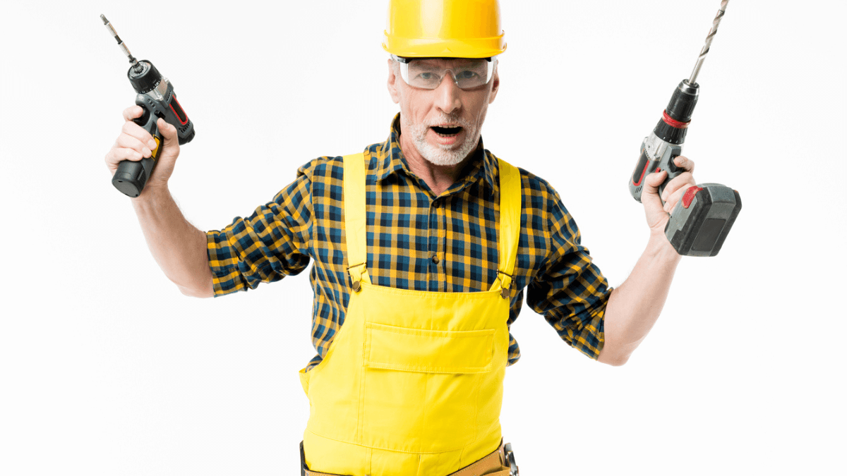 Workman holding electric drills