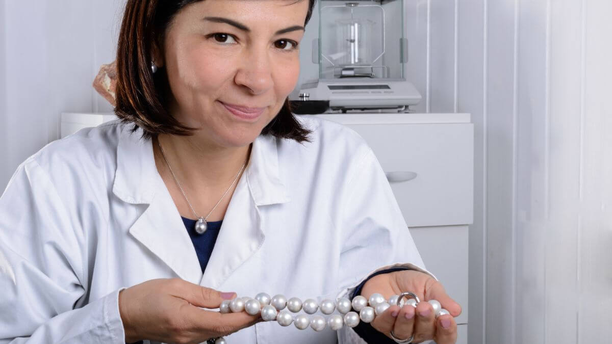 Gemologist holding pearls in her laboratory MSN