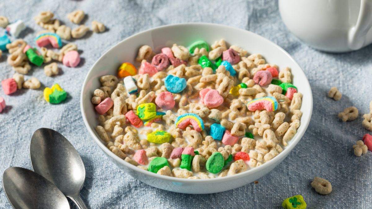 Lucky Charms cereal on a bowl with milk and spoons MSN