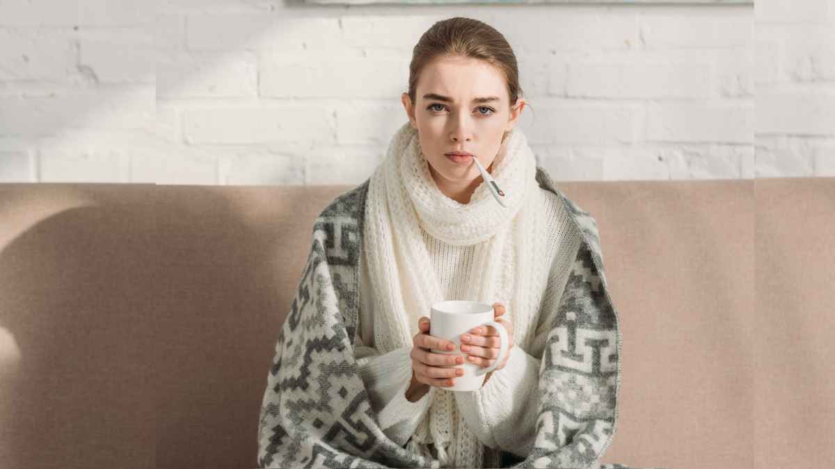 Sick girl wearing jacket while measuring temperature MSN.