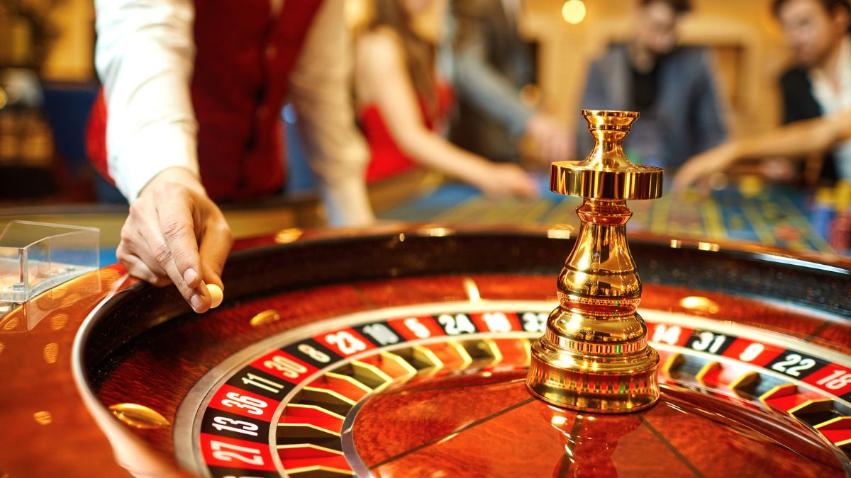 The croupier holds a roulette ball in a casino MSN