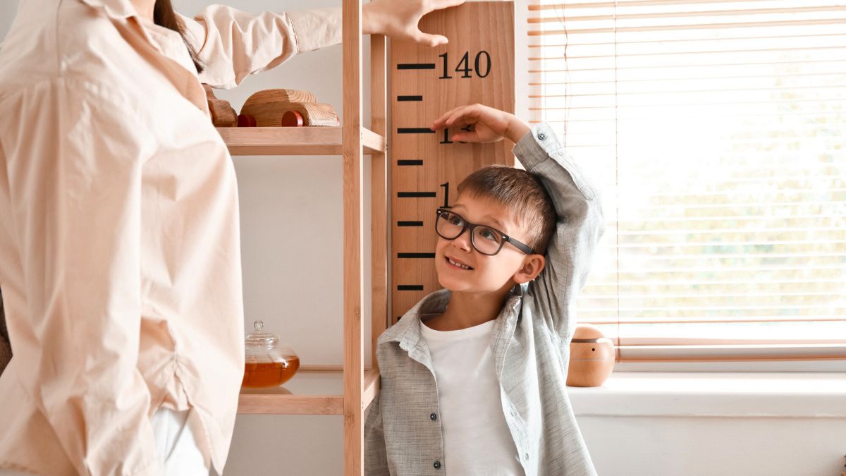 Young Boy Measuring His Height MSN