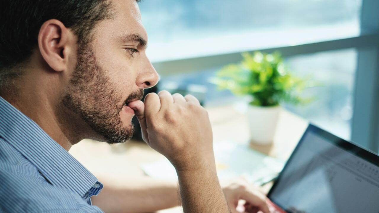 Man Biting Nails Working With Laptop MSN