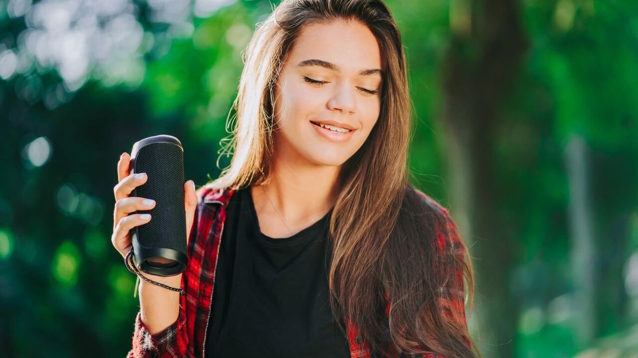 Modern Trendy Girl Listening To Music By Wireless Portable Speaker MSN