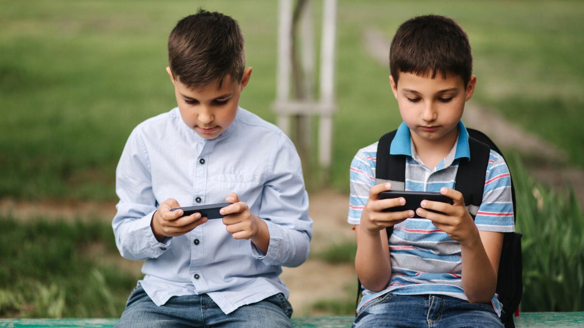 Two Kids Playing Mobile Games MSN
