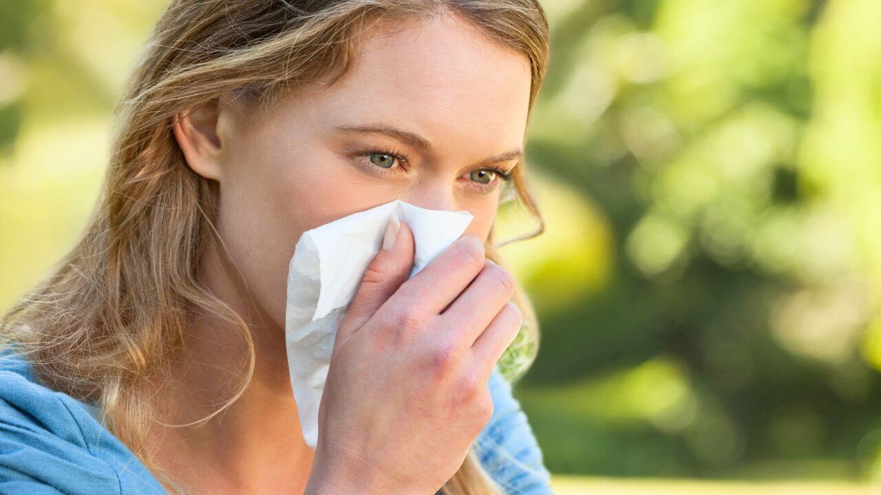 Woman Blowing Nose with Tissue