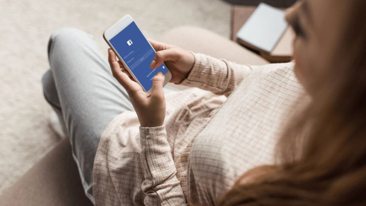 Resized Woman Typing On Facebook Phone