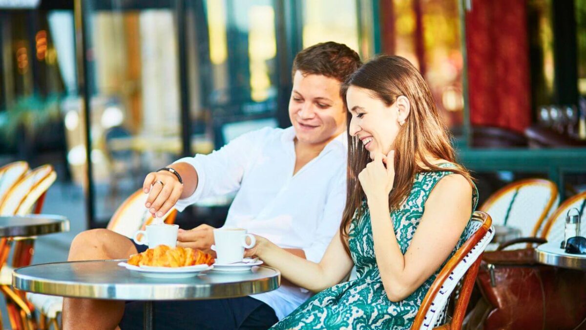 Young Couple In A Cozy Outdoor Cafe