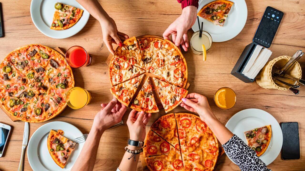 Group of People Eating Pizza