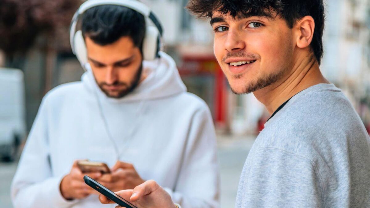 Young People in the Street Holding Phone
