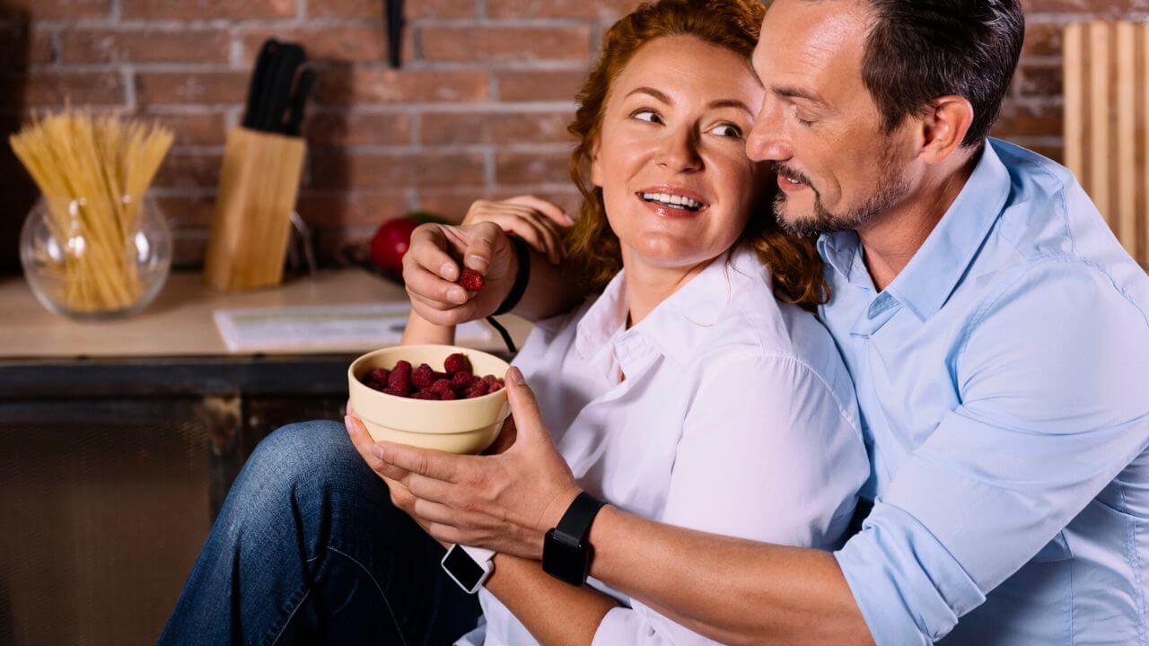 Couple Hugging and Eating Berries
