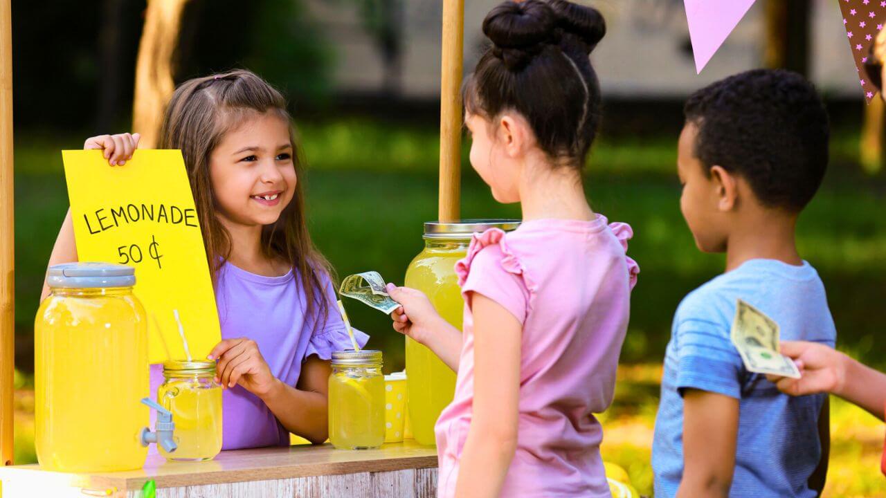 Little Girl Selling Natural Lemonade to Kids in Park